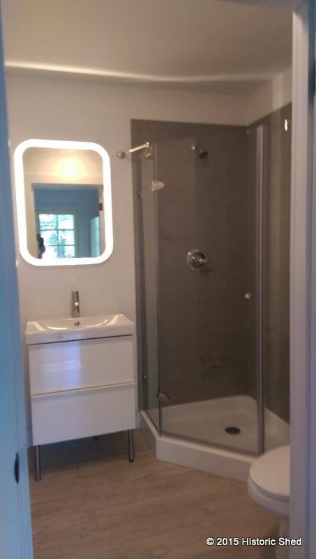 The 5'-6"x5'-6" bath has a shower, vanity and toilet, as well as a washer/dryer closet